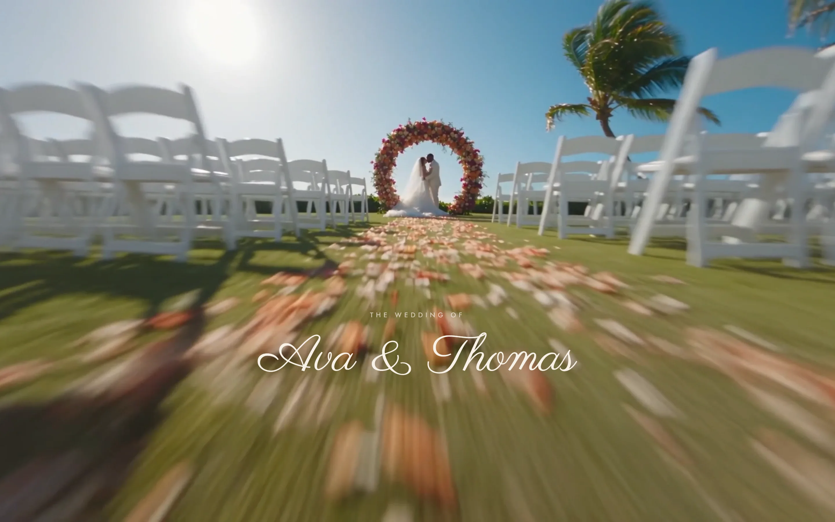 A wedding website mid-scroll: the camera rushes down a petal-covered aisle toward a floral arch and the couple, with their names over the film